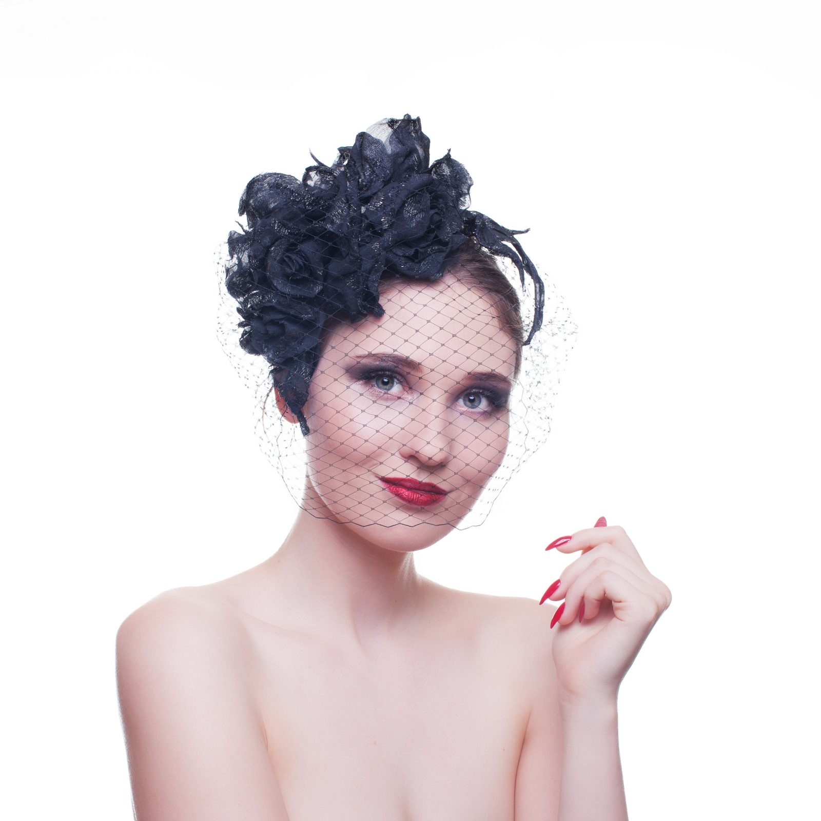 A black hat with a racing veil